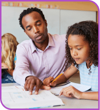 Man teaching a girl to do her homework