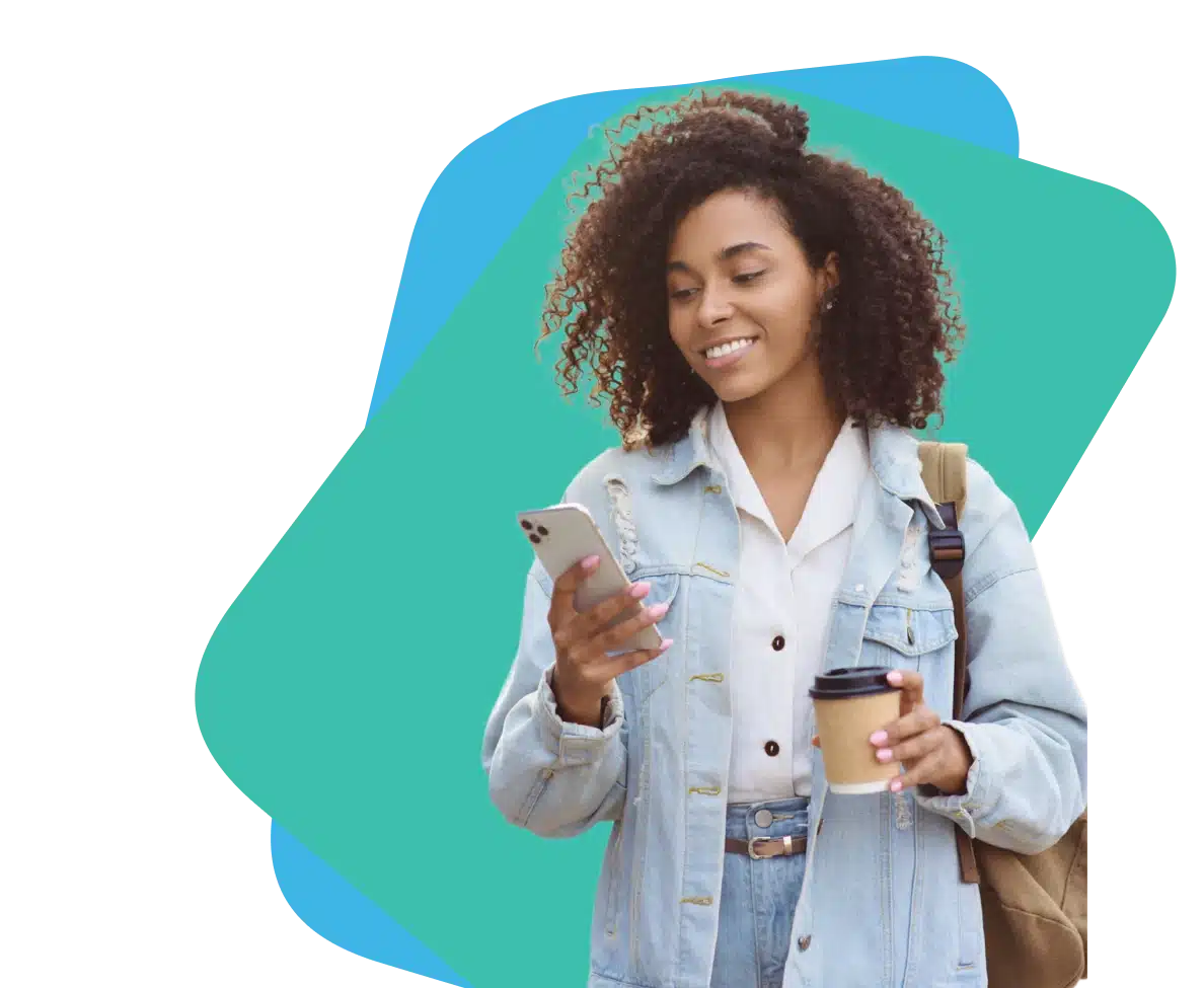 Woman holding a phone in one hand and coffee cup
