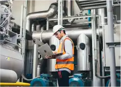 Industry safety employee working on a laptop