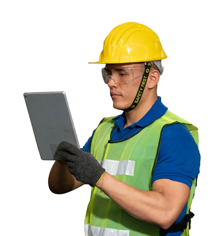 A worker in a hardhat reviewing information on a tablet