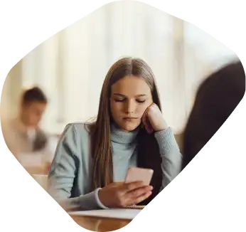Woman in distress looks at her phone